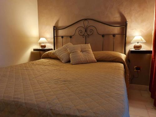 a bedroom with a large bed with pillows on it at Villa Antonella in Carlentini