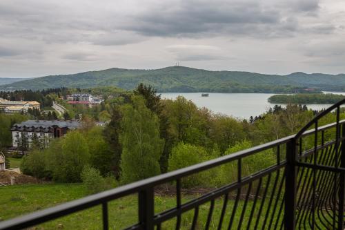 a view of a lake from a balcony at Willa Nova in Polańczyk