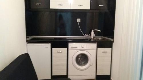 a bathroom with a washing machine and a sink at STUDIO SUNRISE in Varna City