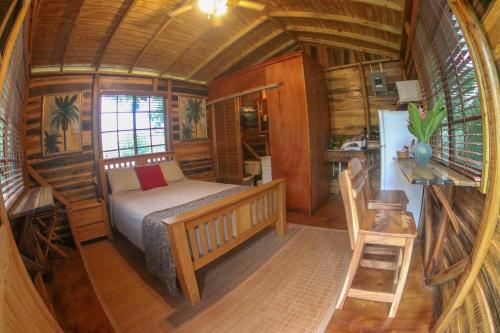 a bedroom with a bed in a wooden cabin at Log 33 in Ocho Rios