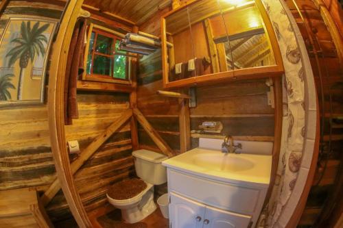 a bathroom with a sink and a toilet in a room at Log 33 in Ocho Rios