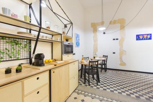 
a kitchen that has a table and chairs in it at Residenza le Scalette in Cagliari
