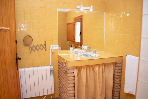 a bathroom with a sink and a mirror at Casa Cueva Salamandra in Pozo Alcón
