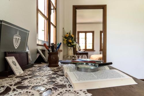 a table with an open book and a mirror at Casa Ermo Colle in Sant'Ermo