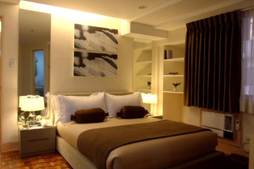 Säng eller sängar i ett rum på Prince Plaza II Condotel