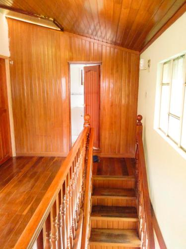 a staircase in a home with wooden walls and wooden floors at Belmont B&B in La Paz