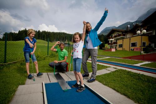 a group of children standing on a skateboard ramp at Gasthaus-Landhotel Traunstein in Abtenau