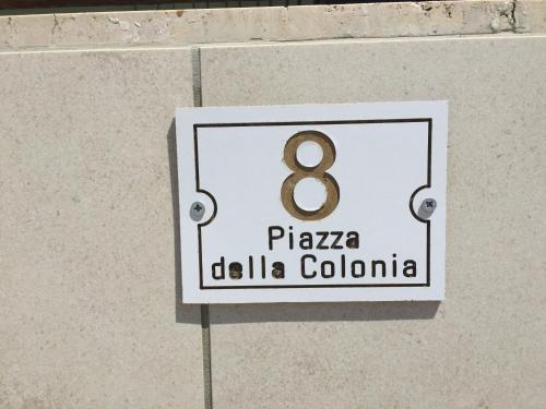 a sign on a wall with the number eight at Relax Near The Sea in Noto Marina