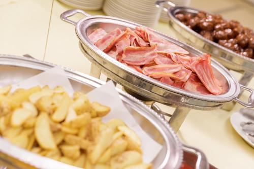 a bunch of food in trays on a table at Hotel Shion in Morioka