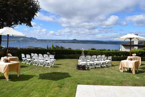 a group of chairs and tables and umbrellas at Bellevue Boutique Lodge in Taupo