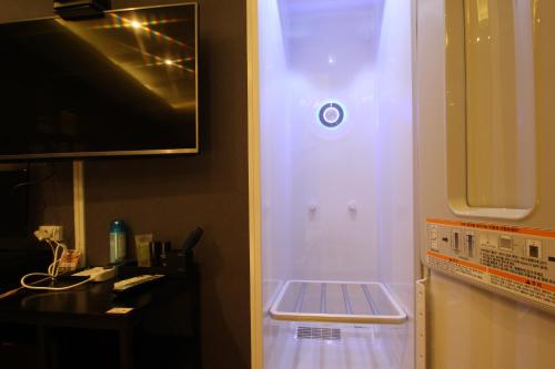 a white refrigerator with its door open in a kitchen at French code Hotel in Changwon