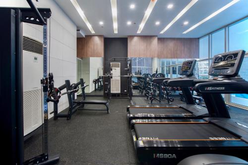 a gym with treadmills and elliptical machines at The Sphere Serviced Residences Managed by HII in Manila