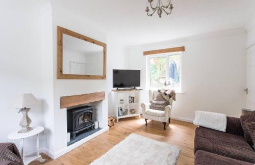 a living room with a couch and a fireplace at Afan Forest House - Private doubles or Twin options! Perfect for Contractors! in Port Talbot
