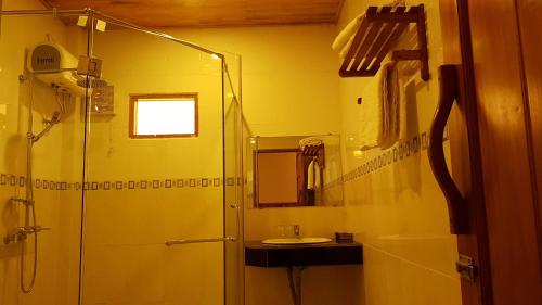 a bathroom with a shower and a sink at Free Beach Resort in Phú Quốc