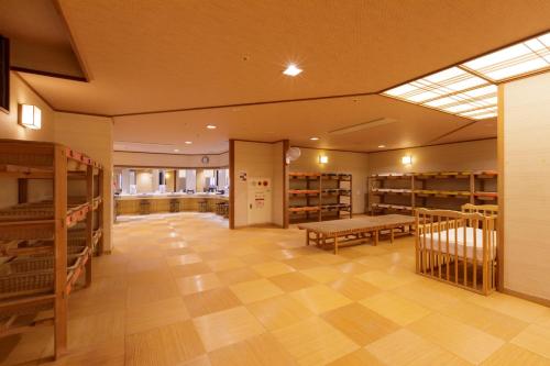 a large room with bunk beds and a library at Hotel Shion in Morioka