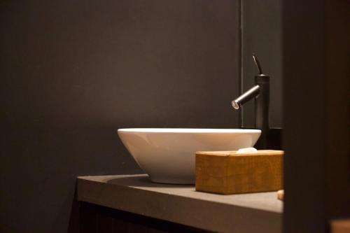 a white bowl on top of a counter with a sink at LombokLodge Apartment Knokke in Knokke-Heist