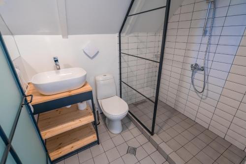 a bathroom with a sink and a toilet and a shower at Kazbegi View in Stepantsminda