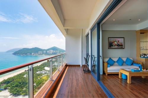 a living room with a view of the ocean at Sanya Dadonghai Seaview Hotel in Sanya
