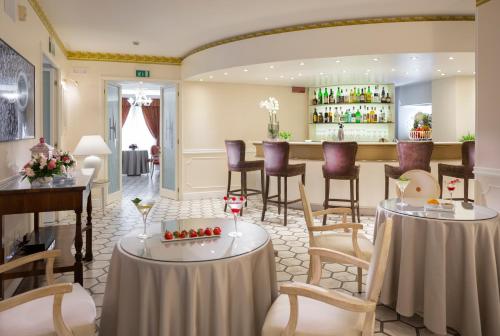 a restaurant with tables and chairs and a bar at Hotel Milton Rimini in Rimini