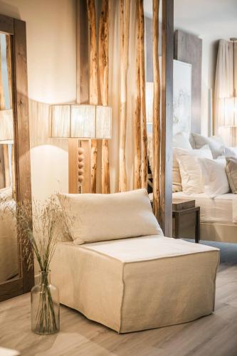 a living room with a couch and two beds at Palladium Hotel in Platis Yialos Mykonos