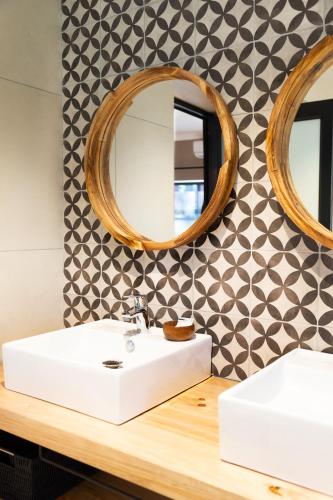 a bathroom with a sink and a mirror at Loerie Guest Lodge in George