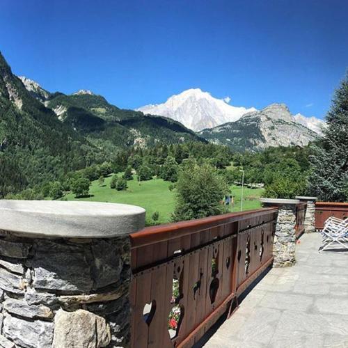 a stone balcony with a view of a mountain at Hotel Beau Sejour Pré-Saint-Didier in Pré-Saint-Didier