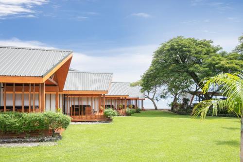 a house with a green yard in front of it at Coral Sea Resort & Casino in Honiara