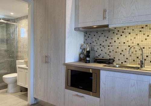 a kitchen with a sink and a toilet at Iliovasilema in Platy