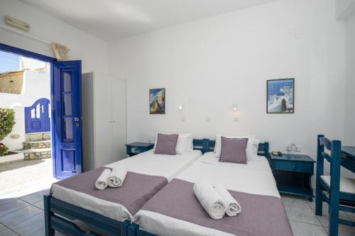 a bedroom with a large bed with towels on it at Villa Happening in Imerovigli