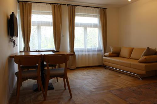 a living room with a table and a couch at Penzion Radost in Poděbrady