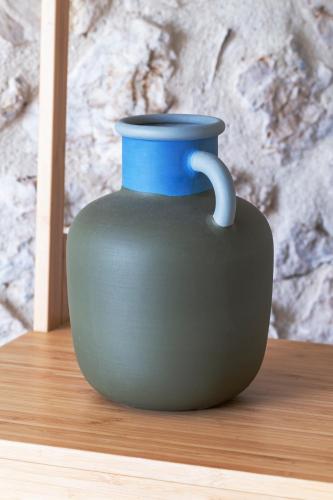 a blue vase sitting on a wooden table at Hotel Marathia in Arta