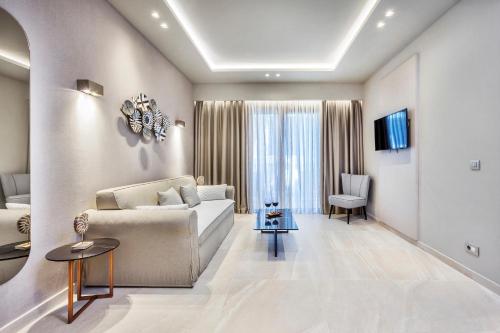 a living room with a couch and a table at Pefki Deluxe Residences in Pefkohori