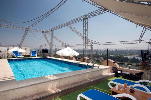 a swimming pool on the roof of a building at Swiss Inn Nile Hotel in Cairo