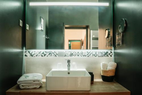 a bathroom with a white sink and a mirror at LE PATIO DE CLARA in Le Touquet-Paris-Plage