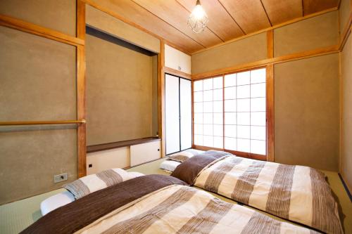 Ένα ή περισσότερα κρεβάτια σε δωμάτιο στο Gunma House