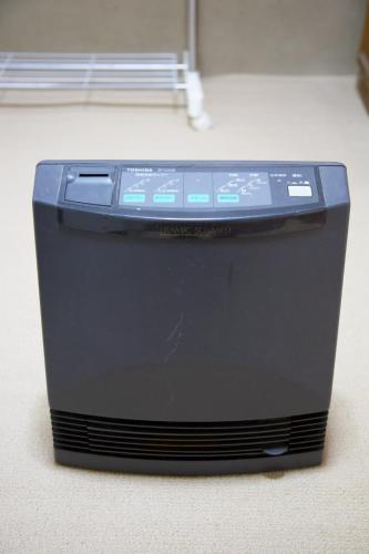 a black computer tower sitting on a floor at Gunma House in Maebashi