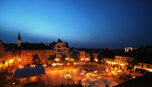 a view of a city at night with lights at Hotel & Apartments Ventus Rosa in Bielsko-Biala