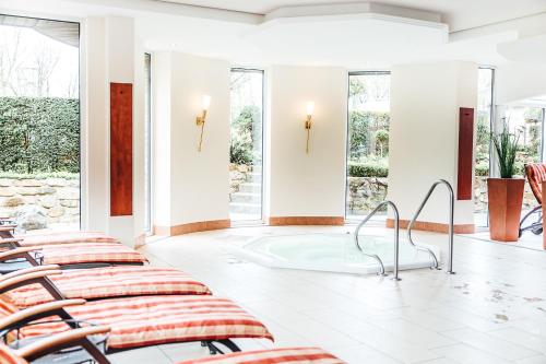 a row of chairs in a room with windows at Ringhotel Teutoburger Wald in Tecklenburg