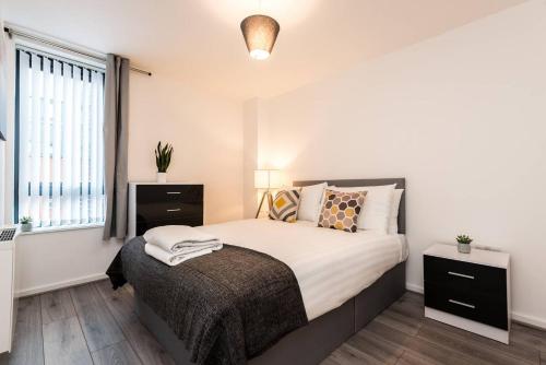 a bedroom with a bed and a window at Host & Stay - Oldham Place in Liverpool