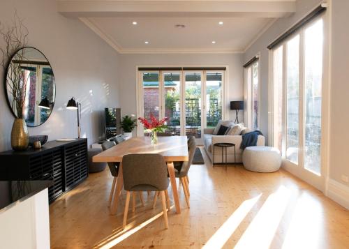 a living room with a wooden table and chairs at House at No. 10 in Ballarat