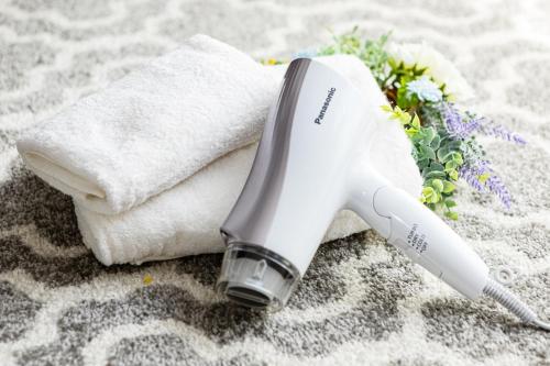 a hair dryer sitting on top of a towel at Andnext Holiday House in Kyoto