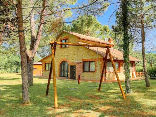 a swing set in front of a house at Colours and scents from Tuscany await you in this wonderful property in Terranuova Bracciolini