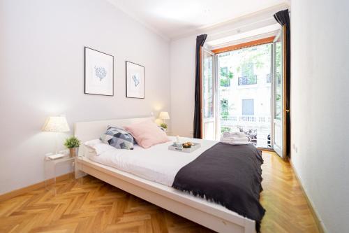 a bedroom with a bed and a large window at Apartamentos Plaza de España in Madrid