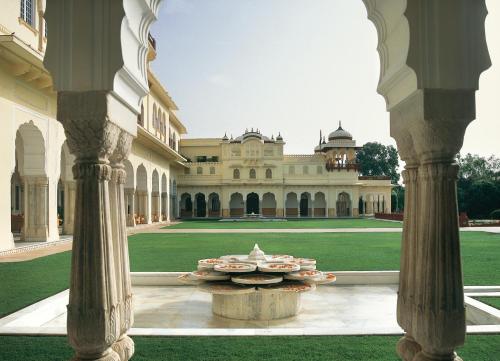a group of plates on a table in front of a building at Rambagh Palace in Jaipur