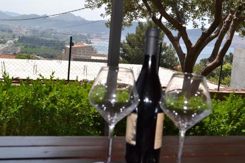 two glasses of wine sitting on a table at Apartments Milosevic in Bar