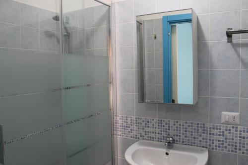 Un baño con ducha, lavabo y espejo. en Bed & Breakfast 21, en Gela