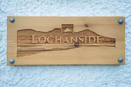 a sign on a wall that reads loadamistle at Lochanside in Struan