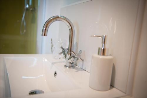 a bathroom sink with a faucet and a mirror at Lochanside in Struan