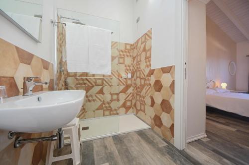 a bathroom with a sink and a shower at La Locanda di Cucco in Finale Ligure