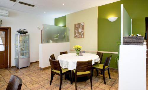 a dining room with a table and chairs at Pension Pegast in České Budějovice